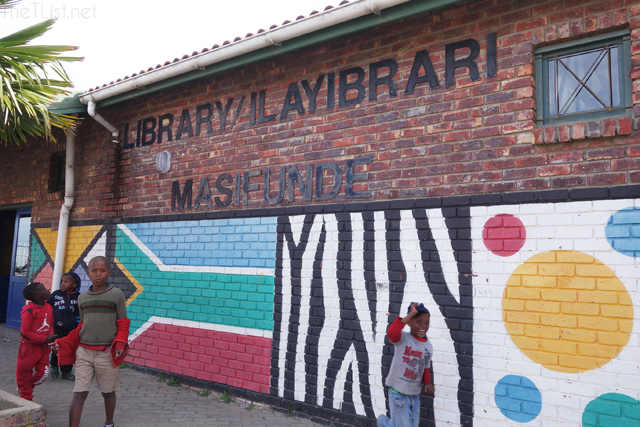 Children playing outside the library in the township